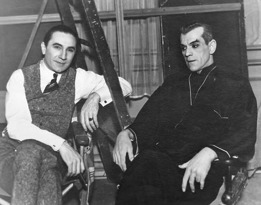 A black and white photograph of Boris Karloff and Bela Lugosi. Lugosi looks at the camera, and Karloff wears a pensive look. 
