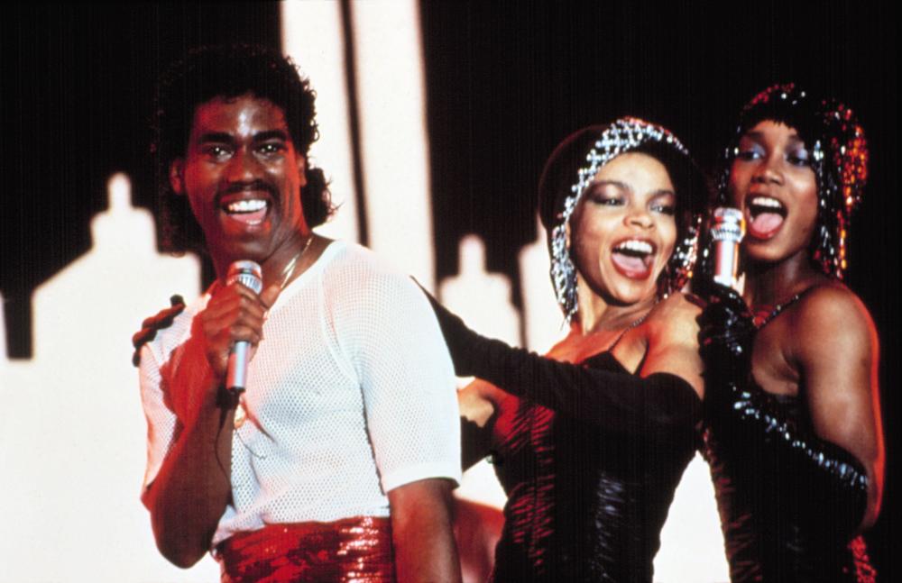 A performance of the song "If I Ruled the World" by Kurtis Blow with two backup singers, as seen in the film "Krush Groove" (1985). 