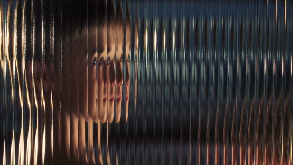Haley Joel Osment’s David is viewed through thick, undulating glass that distorts and doubles his image—showing each of his features, notably his eyes, half a dozen times.