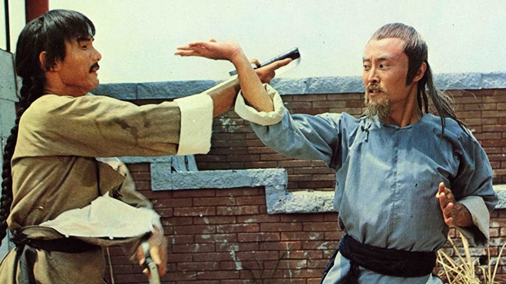 Sun Hung (Corey Yuen) fights Shang-Kuan Cheng with a brick wall in the background in "7 Grandmasters."