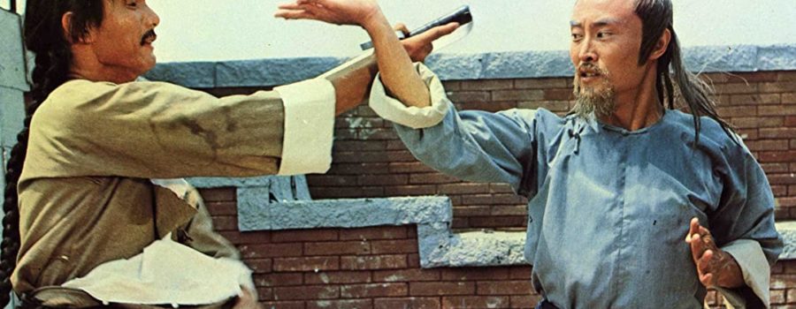 Sun Hung (Corey Yuen) fights Shang-Kuan Cheng with a brick wall in the background in "7 Grandmasters."