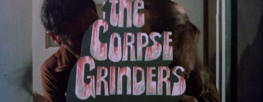 The title "The Corpse Grinders" appears over an image of a man and woman embracing.