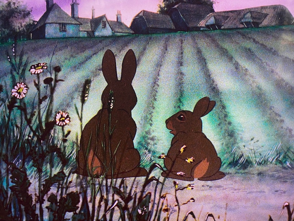 Two rabbits discuss the pros and cons of exploring a farmhouse in the distance. Source: Watership Down.