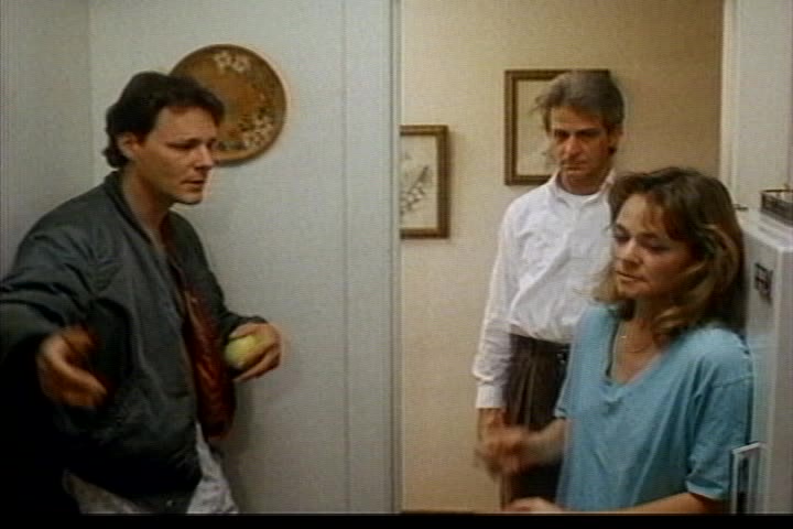 Billy, Eddie and Patti engaged in group therapy. (Three people stand in a kitchen talking.)