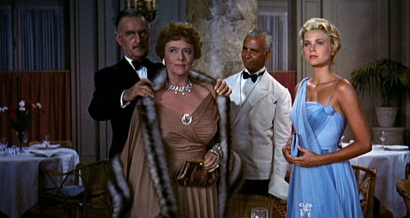 A color image of Frances Stevens, a white, blonde woman, Jessie Stevens, an older woman with red hair, H. H. Hughson, a man with graying hair and a moustache, and a waiter wearing a white suit and black bowtie.