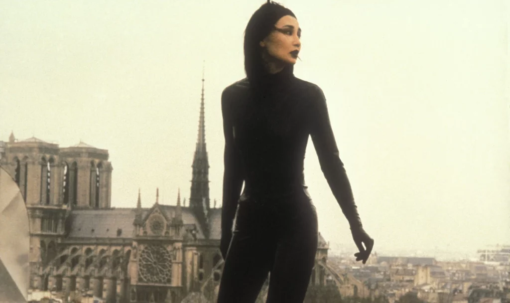 Maggie Cheung, a Hong Kongactor, donning the titular Irma Vep's catsuit on a rooftop overlooking Paris. 