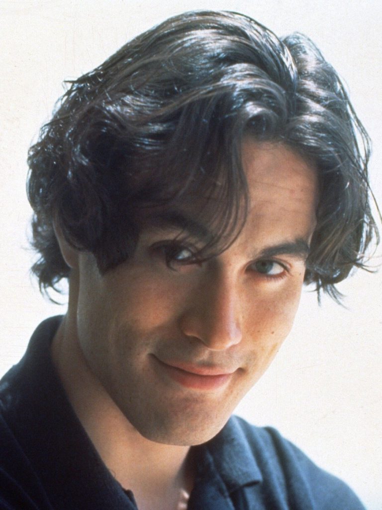 Headshot of Brandon Lee. He has black hair that flops over to the side, and dark brown eyes. He is wearing a black collared shirt. Brandon Lee is smiling.