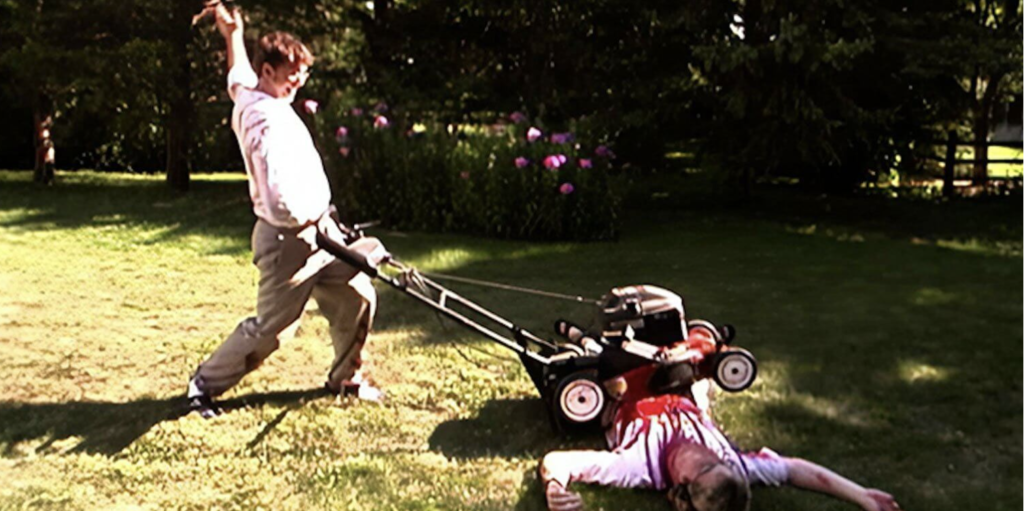 A grainy image of a man dressed in a white button down mowing over another man with a lawnmower. The injured man lays on the ground covered in blood. The men are outdoors, with a row of trees in the background.