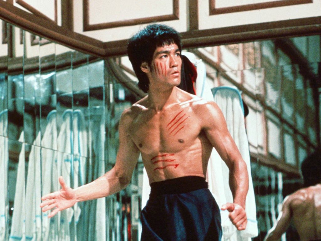 Brandon Lee's father, Bruce Lee, in Enter the Dragon. He is standing in mirrored room, and is covered in violent scratches.
