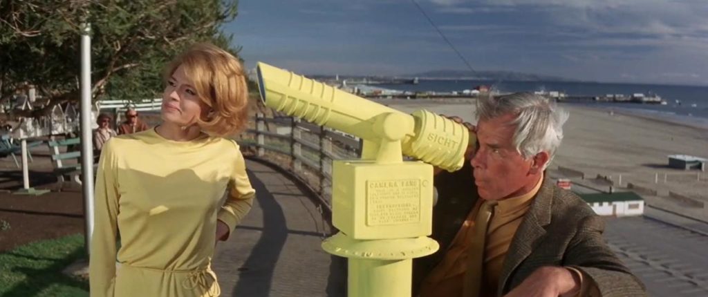 Walker looks through a bright yellow telescope with Lynn who is wearing a bright yellow outfit.