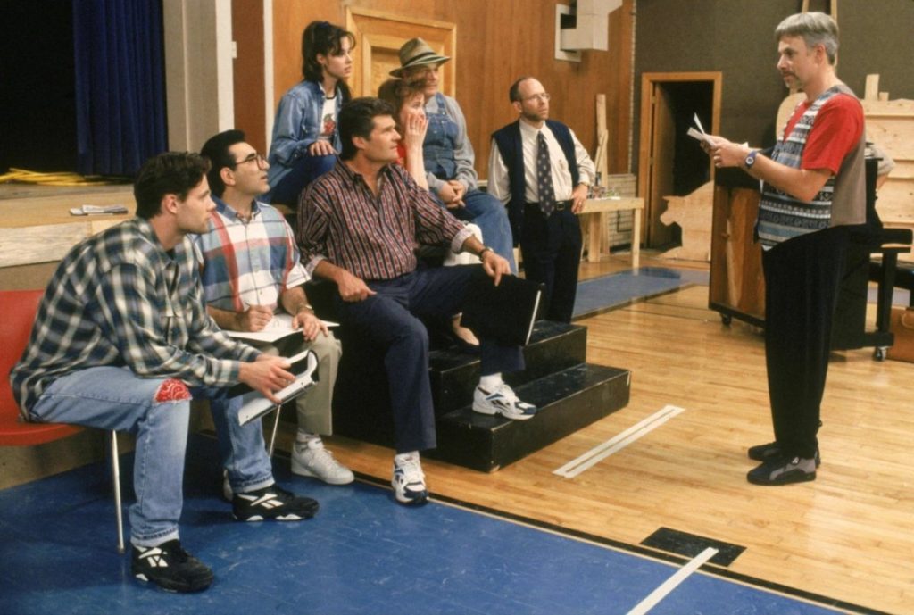 The cast of Red, White and Blaine sit and listen to director Corky St. Clair