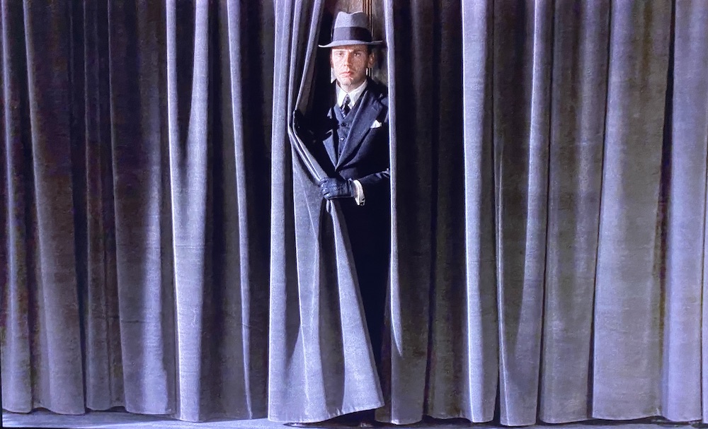 Clerici emerges from behind a wall of grey curtains.
