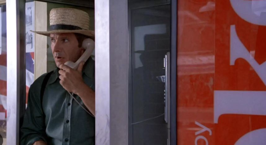 Harrison Ford in phone booth in scene from Witness