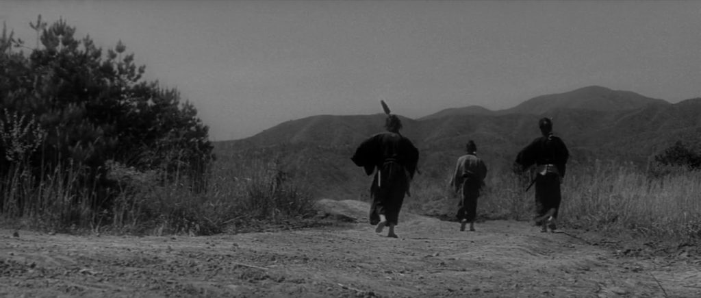 Shot of the three samurai walking into the distance down a dirt road