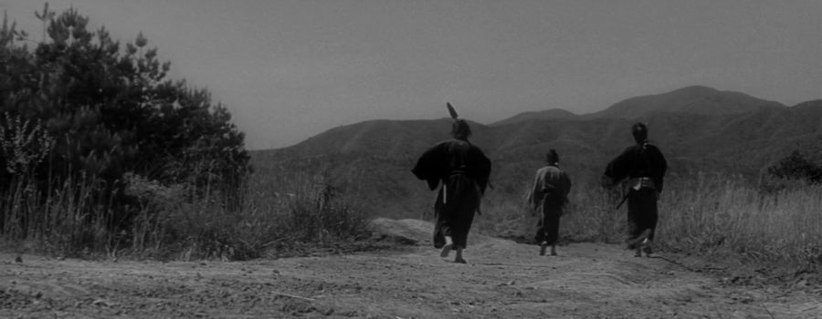 Shot of the three samurai walking into the distance down a dirt road