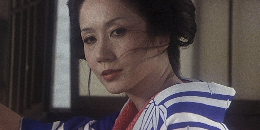 A close up shot of a woman wearing a blue and white robe with red lining on the inside.