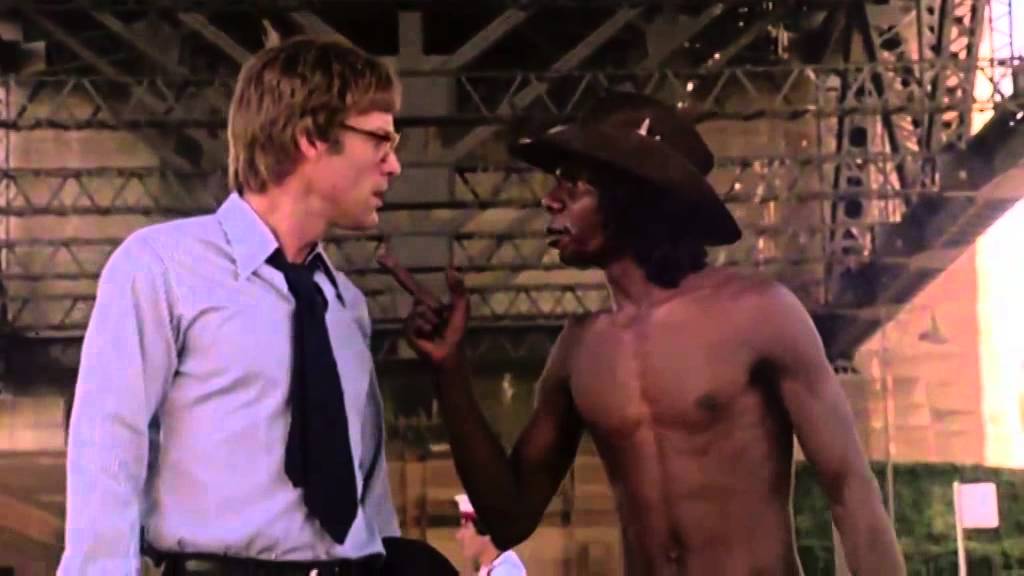 Richard Chamberlain, who plays a white lawyer, and David Gulpilil, an Aboriginal man, confronting each other. 
