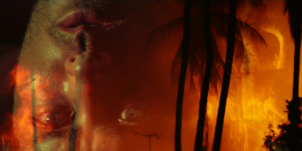 Upside down image of Martin Sheen as Captain Willard dissolving into right side up image of face of ancient statue.