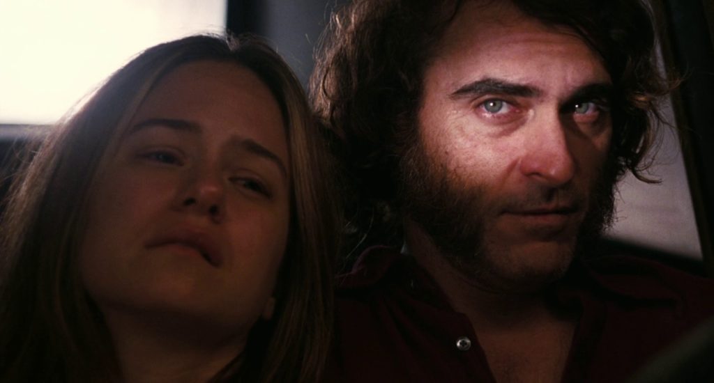 Joaquin Phoenix looks towards the camera knowingly, from the film Inherent Vice.