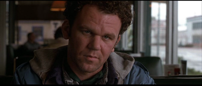 John C. Reilly looking off camera.