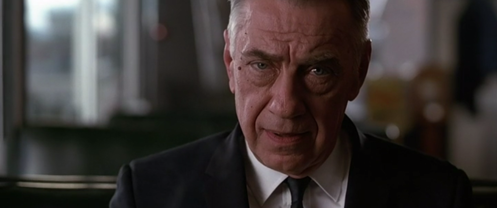 Philip Baker Hall looking directly at the viewer.
