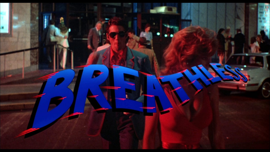 Still from the opening scene of the remake of Breathless. The blue flowing title is superimposed over Richard Gere.