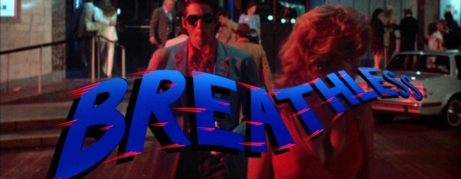Still from the opening scene of the remake of Breathless. The blue flowing title is superimposed over Richard Gere.