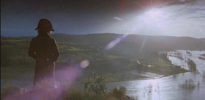Harvey Keitel as Feraud standing on a cliff overlooking a river and fields