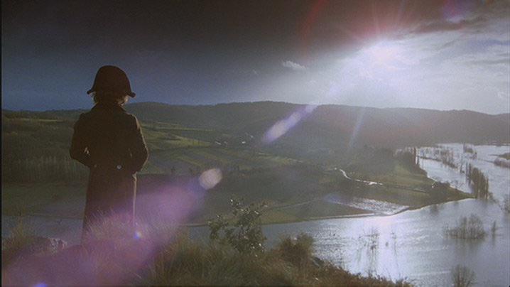 Harvey Keitel as Feraud standing on a cliff overlooking a river and fields.
