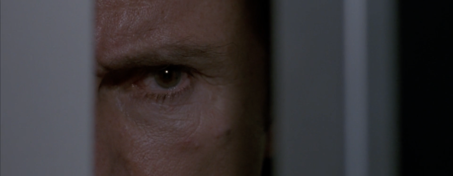 Harvey Keitel as Bad Leutenant is lurking through a barely open door