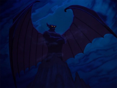 A large monster with bat-wings stands on top of a mountain.