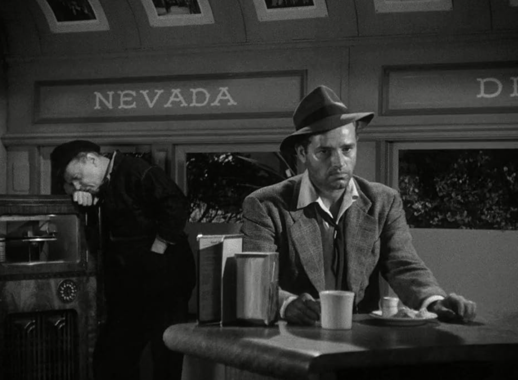 Al sits at a darkened diner counter.