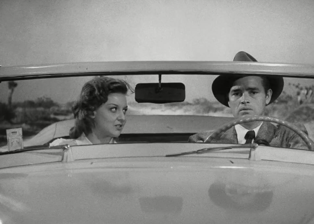 Al and Vera sit in Haskell’s car, driving on the highway.