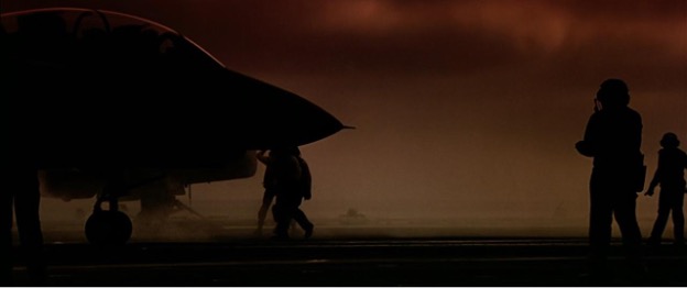 A fighter jet on a runway at dusk
