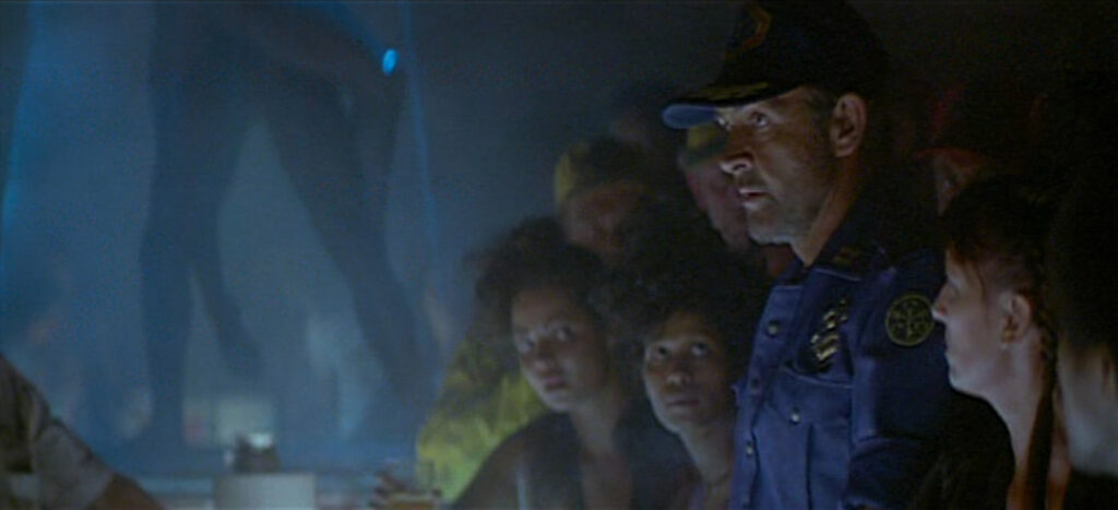 Marshal O'Niel, played by Sean Connery, stands at a bar. The patrons all look at him, knowing he's marked for death.