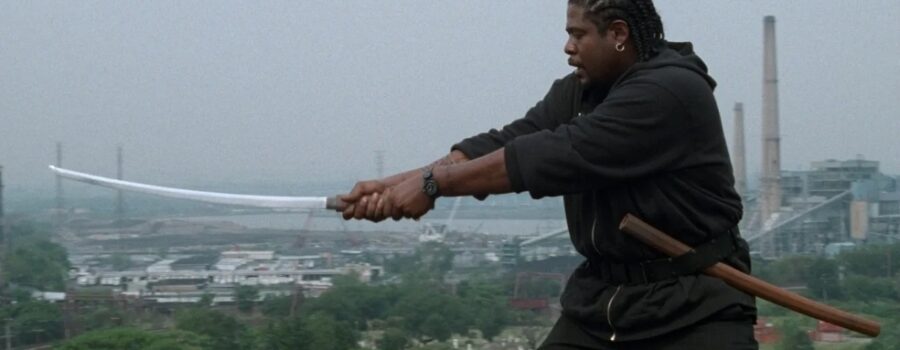 Ghost Dog, played by Forrest Whitaker, practices his sword work on a roof top.