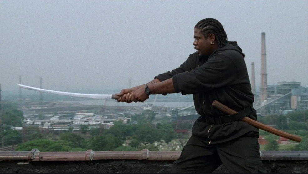 Ghost Dog, played by Forrest Whitaker, practices his sword work on a roof top.