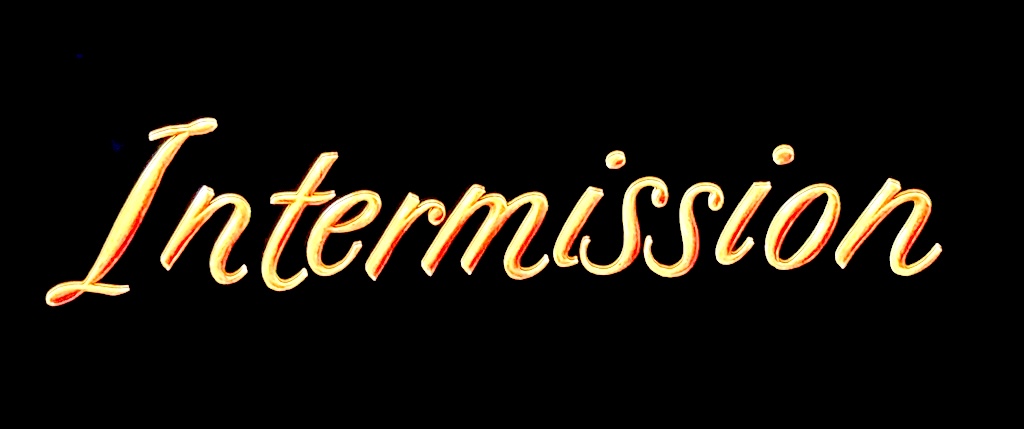 Intermission screen, simply reading “Intermission” in ornate gold font on solid black background.