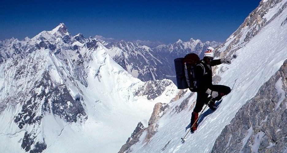 A man climbs a mountain.