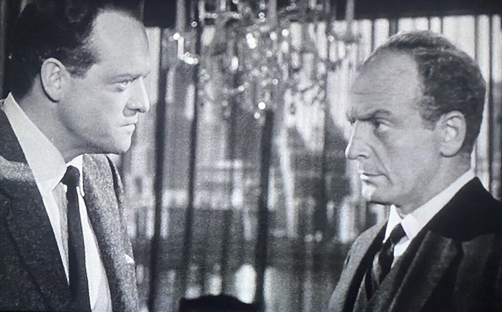 Two businessmen argue with each other in a corporate office.