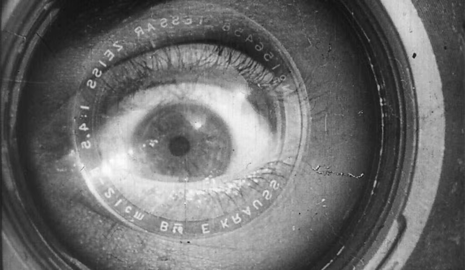An eye superimposed over a camera lens