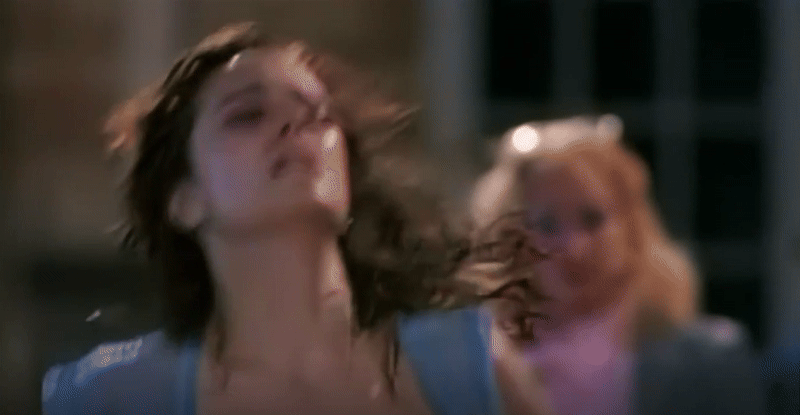 A medium close-up of Samantha in shallow focus, running in place at her dance-ercise studio, and drenched in perspiration. In her signature periwinkle shirt and armbands, her dark hair soaked and flopping on her face and shoulders, the look on her face is fierce and committed. She looks off to her left, mascara diffuse on her gleaming skin. A dance competition judge is out-of-focus behind her, but perhaps Samantha is her own greatest judge.