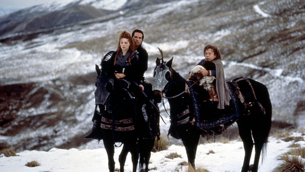 Sorsha (Joanne Whalley), Madmartigan (Val Kilmer), Willow (Warwick Davis) and the Princess Elora on horseback.