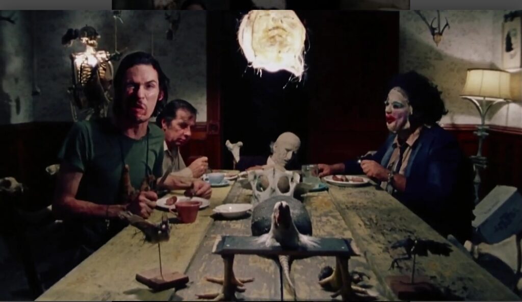 Dinner table from Sally's perspective, with the Sawyer family in frame ready to torture her.