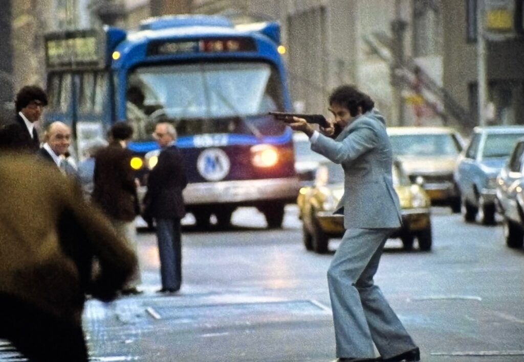 Dan Hedaya as Sgt. Barnes firing shotgun rounds in a crowded NYC street.