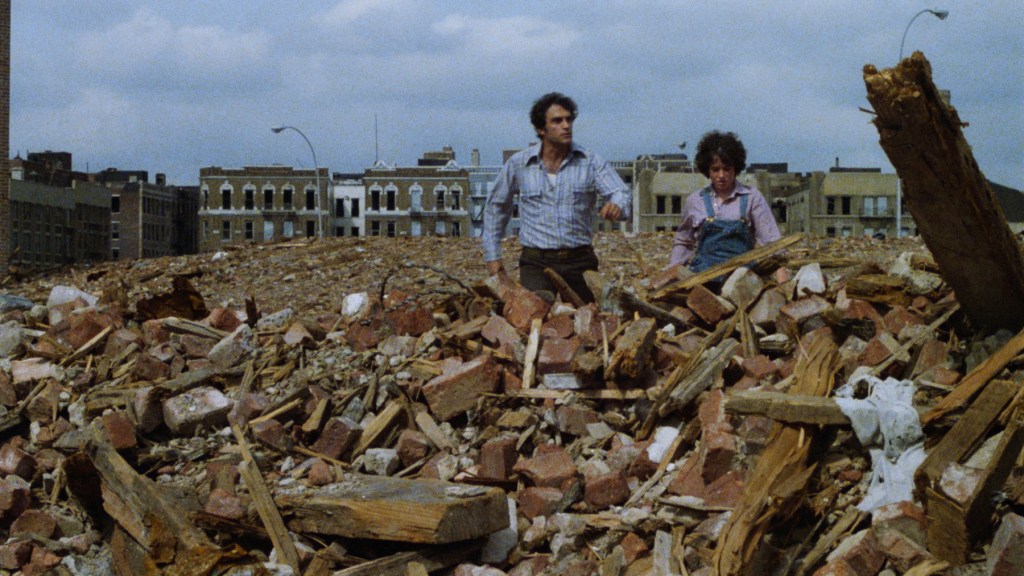 Cliff Gorman as Gus Soltic and Abby Bluestone as Kathy Boyd walk across South Bronx ruins