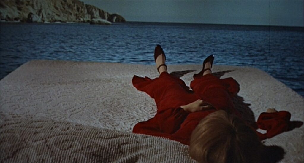 Rosemary lies on a bed, floating in the sea. 