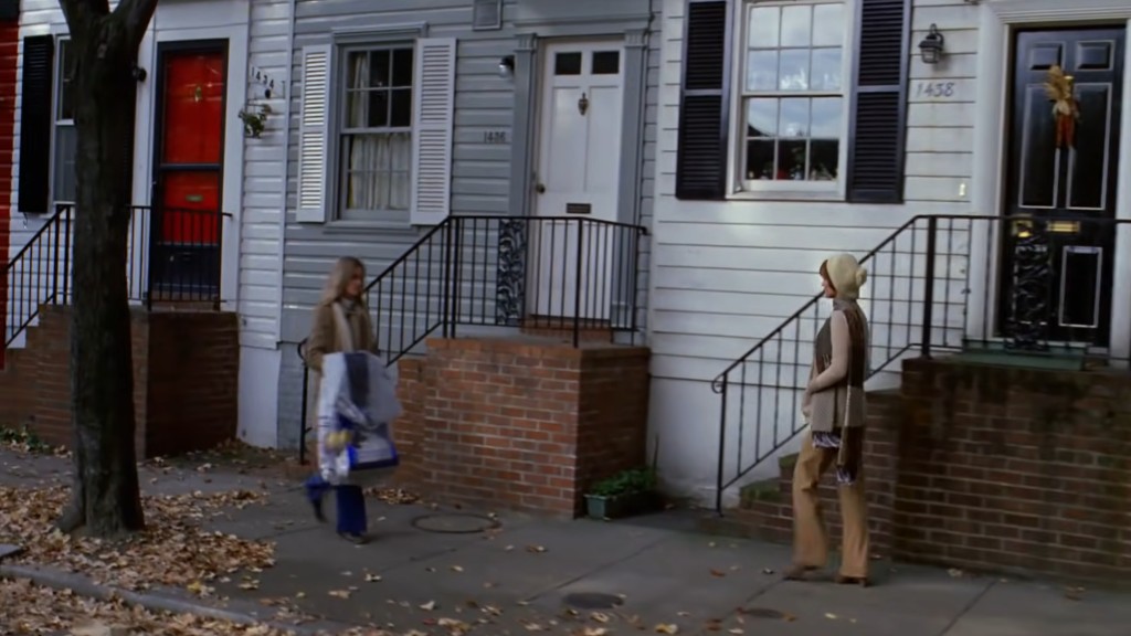 Chris walks home from her job, passing several rows of houses in a Georgetown neighborhood.
