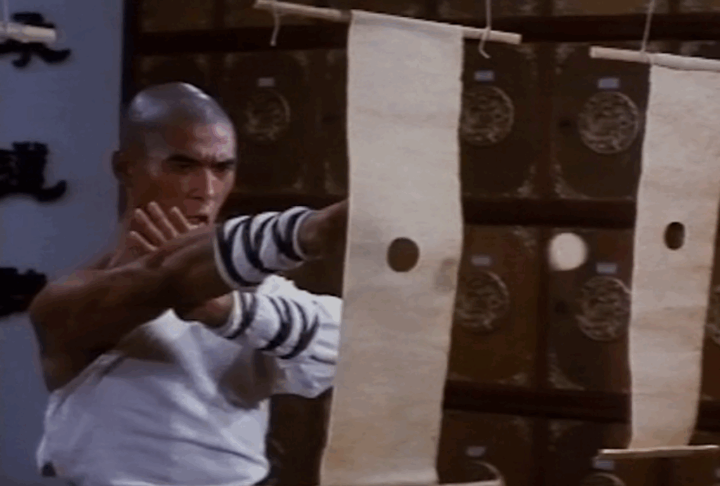 A buddhist monk trains by punching perfect circles out of paper.