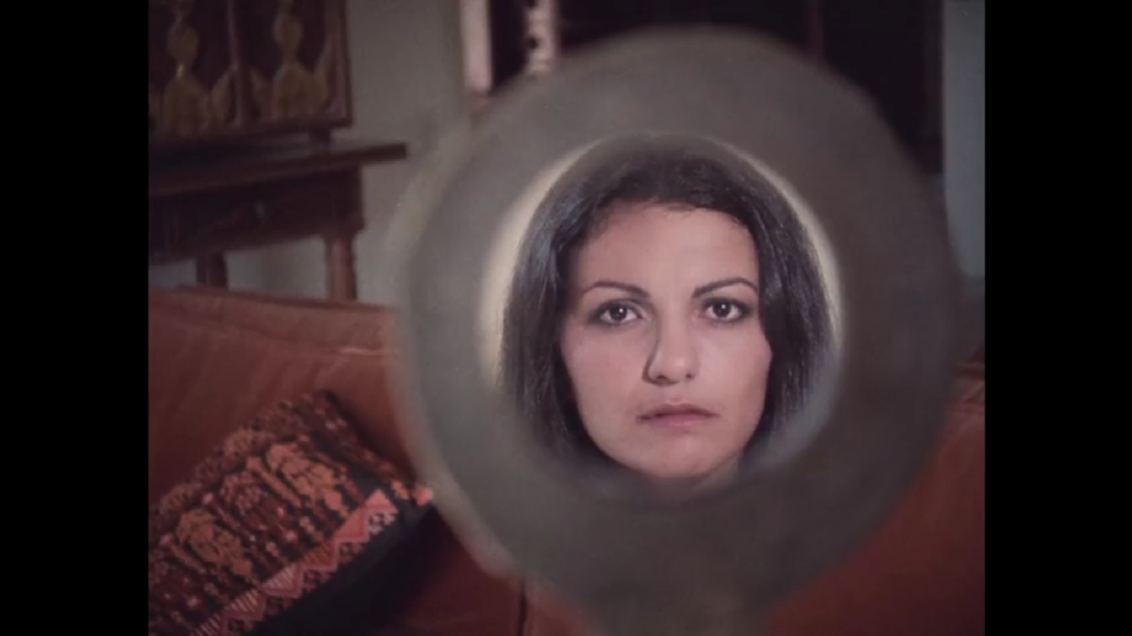  A young girl’s reflection in a hand mirror. Her eyes look into the lens as she wonders if she will be like her grandmother.
